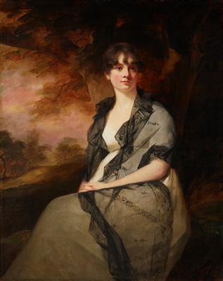 Mrs. Bell is wearing a white gown and filmy grey shawl trimmed with black lace.